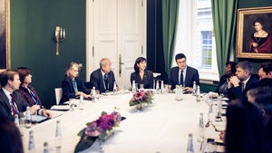 Group of people sitting around a table in conversation.