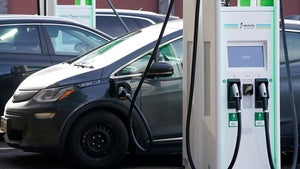 An electric vehicle plugged in at a charging station