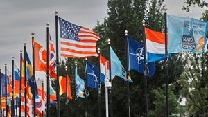 Participants' flags wave in the wind in front of the venue ahead of the NATO summit in The Hague