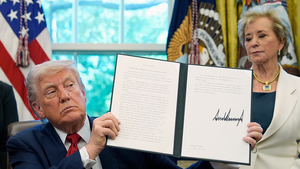  President Donald Trump holds a signed an executive order relating to school discipline policies as Education Secretary Linda McMahon stands behind him at the Oval Office.