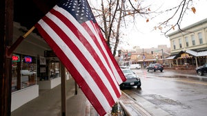 An American flag hangs in front of a store in Colorado