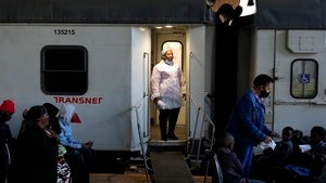 Person standing at the doorway of a mobile clinic
