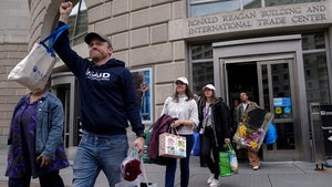 United States Agency for International Development (USAID) workers, carry their personal belongings after retrieving them from the USAID's headquarters in Washington, Thursday, Feb. 27, 2025