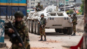 Bangladeshi military force soldiers patrol a street during a nationwide curfew