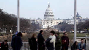 Visitors are seen at the base of the Washington Monument