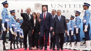 US Vice President JD Vance walks with Pakistani officials after arriving for talks with Iranian negotiators