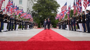 President Donald Trump walks on the red carpet in the Rose Garden with Britain's King Charles III