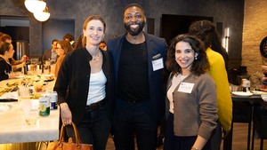Attendees at an Emerging Leaders reception event pose for a photo.