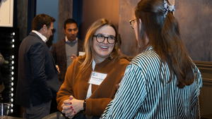 Event attendees at an Emerging Leaders reception talking to one another.