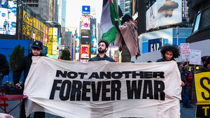 Protestors with a banner that reads "Not another forever war" walk through Times Square in New York on April 8, 2026.