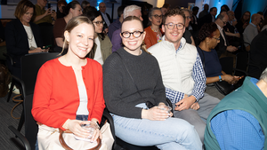 Three Council event attendees smile for a photo.