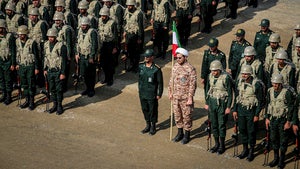 troops stand while attending a maneuver in northwestern Iran