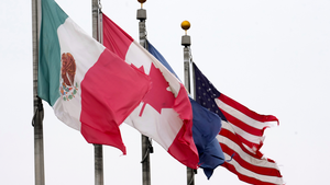 The flags of Mexico, Canada, and the United States fly next to each other.