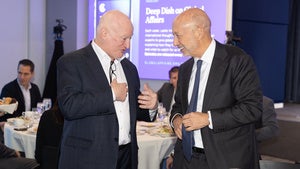 Two people speaking during a Council event
