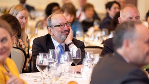 A person in the audience sits at a table