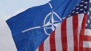 NATO and US flags wave in the wind outside NATO headquarters in Brussels