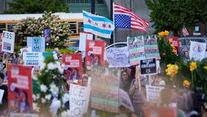 People hold signs and flags at a protest opposing "Operation Midway Blitz" and the presence of ICE, Tuesday, Sept. 9, 2025, in Chicago. 