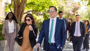 Group of people walking together on street.