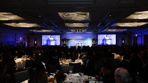 A room full of people sitting at tables
