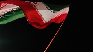A man waves an Iranian flag during a pro-government gathering at a square in Tehran