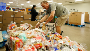 Volunteers sort through food donations at the St. Mary's Food Bank in Phoenix, AZ on June 29, 2022.