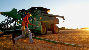 Farmer Brandon Hedges walks back to his combine while harvesting soybeans in Pawnee, IL on October 7, 2010.