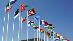 A variety of international flags on flag poles