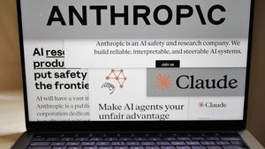 Pages from the Anthropic website and the company's logos are displayed on a computer screen