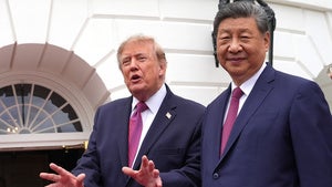 President Donald Trump speaks to reporters during a tour of the South Lawn of the White House with China's President Xi Jinping