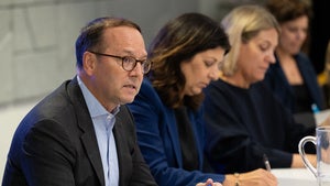 Evan Medeiros speaking at a table