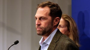 Jason Crow speaks into a microphone