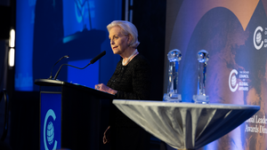 A person speaks at a podium