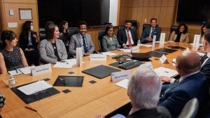 People sit around a large table during a meeting