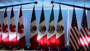 National flags representing Canada, Mexico, and the U.S. are lit by stage lights at the North American Free Trade Agreement, NAFTA, renegotiations, in Mexico City, Tuesday, Sept. 5, 2017.