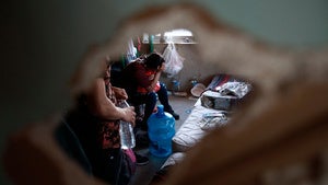 A Central American migrant woman cries in frustration before being removed by police from a house controlled by human smugglers, to transfer her and other occupants to a government shelter from which they will be returned to their native country, in Ciudad Juarez, Mexico, Saturday, July 3, 2021. 