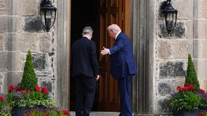 U.S. President Donald Trump, right, and British Prime Minister Keir Starmer walk at Trump International Golf Links in Aberdeenshire, Scotland, Monday, July 28, 2025. 