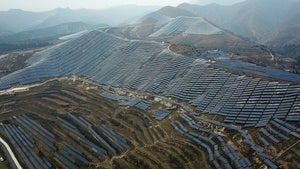 Solar panels sit on a hillside
