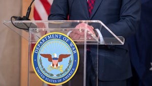 Secretary of Defense Pete Hegseth stands at a podium with a logo at the Pentagon.