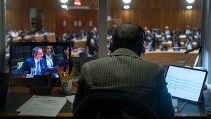 A screen shows Rafael Grossi, left, International Atomic Energy Agency (IAEA) Director General and a candidate for United Nations Secretary-General, speaking during an informal dialogue at U.N. headquarters, Tuesday, April 21, 2026. 