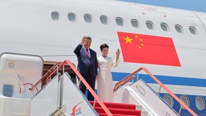 In this photo provided by the North Korean government, Chinese President Xi Jinping, left, and his wife Peng Liyuan arrive at the airport in Pyongyang, Monday, June 8, 2026.