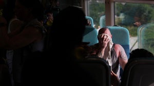 A man on a train wipes sweat from his face on a hot day in London, Wednesday, June 24, 2026.