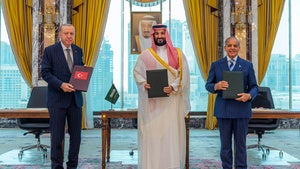 Turkish President Recep Tayyip Erdogan, Saudi Crown Prince Mohammed bin Salman and Pakistani Prime Minister Shehbaz Sharif pose after signing a trilateral defense agreement in Mecca, Saudi Arabia, Friday, Aug. 7, 2026. 